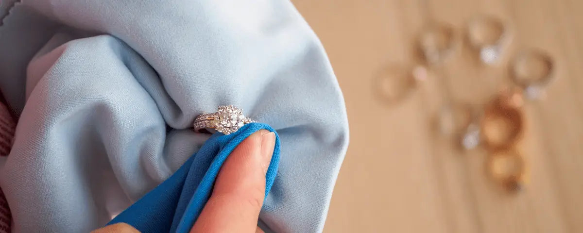 engraved rings resting on blue and pink silk with soft golden bokeh, personalized jewelry care