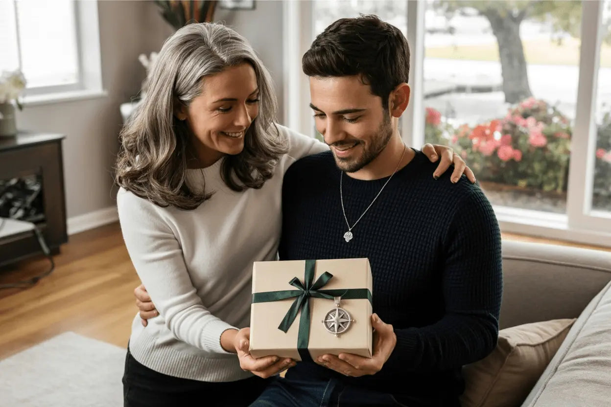 Mother handing her adult son a gift box with green ribbon while he wears a personalized pendant