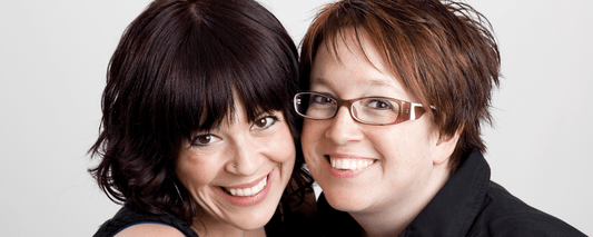 Two unbiological sisters smiling together, showing a deep bond of love and friendship.